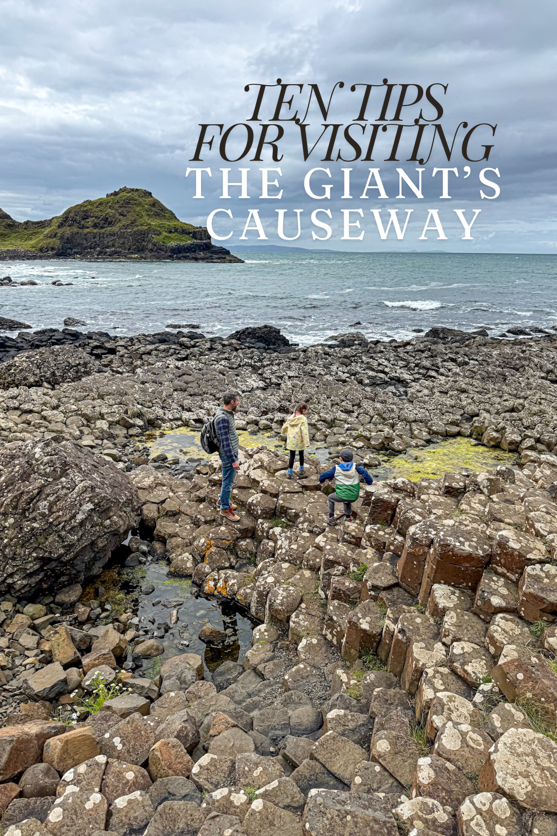A father and 2 kids explore the Giant's Causeway's basalt columns with a title saying "10 tips for visiting the giant's causeway".