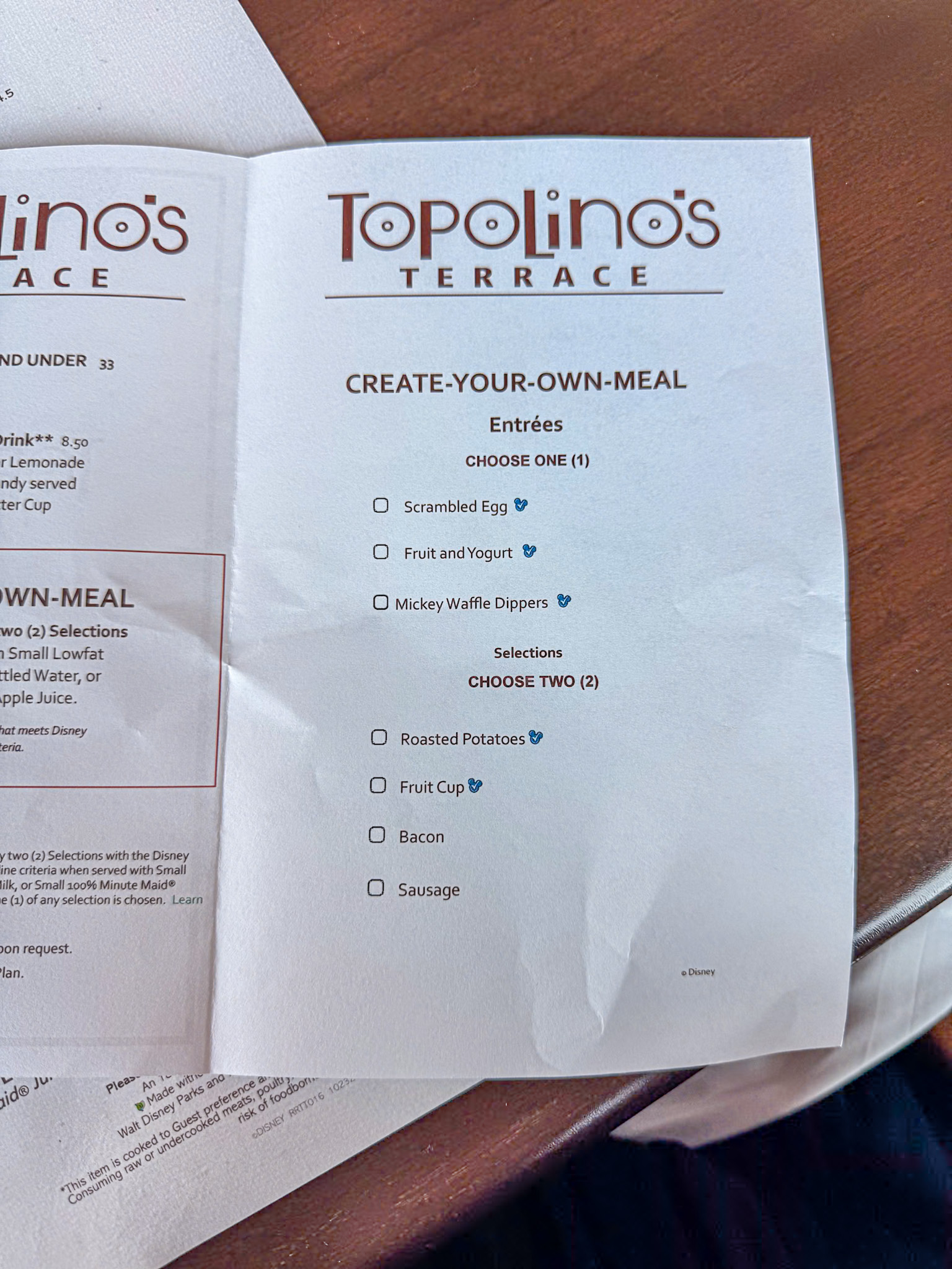 A photo of the children's menu at Disney's Topolino's Terrace showing what mains and sides they can choose for breakfast.