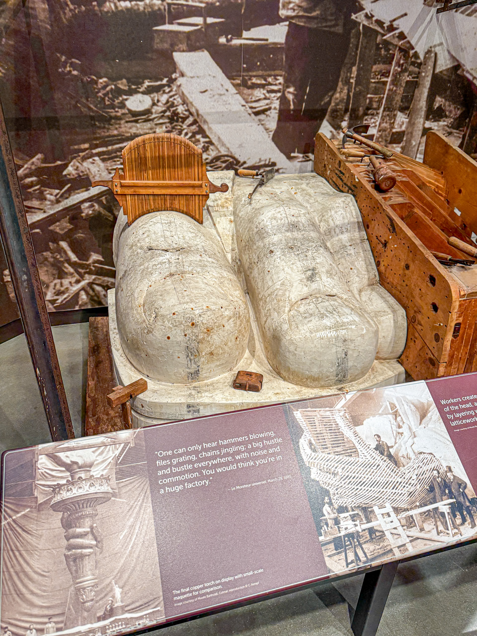 Two large molds for sculpting, displayed in a museum, with informational plaques in front of them.